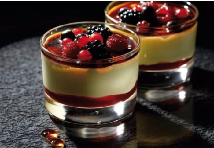 Crème Brûlée & Berries  · A layer of raspberry sauce topped with a creamy custard and decorated with mixed berries coated in caramel.