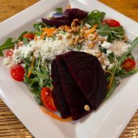 Beet Goat Cheese Salad · Beets, goat cheese, pine nuts, tomatoes over baby spinach in a raspberry vinaigrette.