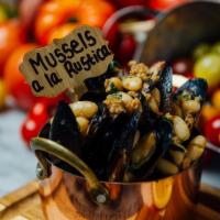 Mussels a la Rustica · Spicy Italian sausage, roasted garlic, cannellini beans, white wine butter broth.