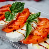 Caprese Salad · Fresh mozzarella, tomatoes, basil, balsamic reduction, and EVOO.