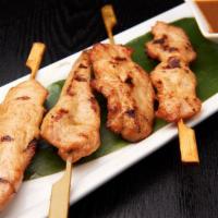 Chicken Satay · 4 pieces.  Grilled chicken in skewers with a garnish of salad.
