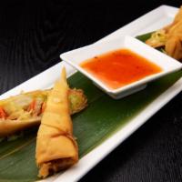 Harvest Spring Rolls · 2 pieces. Shredded vegetables wrapped in a delicate pancake and fried.