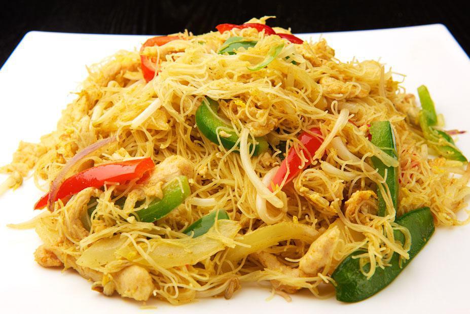Singapore Chicken · Angel hair rice noodles are stir-fried in a wok with chicken, vegetables, seasoned with madras curry powder.