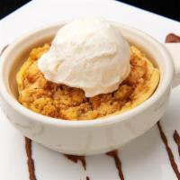 Warm Apple Cobbler · A round shell complete with Granny Smith apples in a beautiful sauce topped off with sugar i...