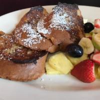 French Toast with Fruit Salad · Sprinkled with powdered sugar and served with butter and syrup.
