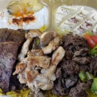 13. Trio-Plate  طبق مشكل .دجاج .لام .بيف · Beef, lamb, chicken, rice, salad, hummus, tzatziki, pita bread.