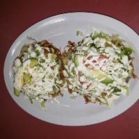 Tostadas de Tinga (2) · Pulled chicken breast cooked in chipotle tomato sauce and onion. Made on a crispy corn torti...