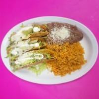 Guacamole taco · 3 hard shell guacamole taco, lettuce, cotija cheese, sour cream with rice and beans