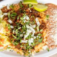 Plato de Birria · Braised beef In Mexican stew served with corn tortillas rice, beans cotija cheese and salad.