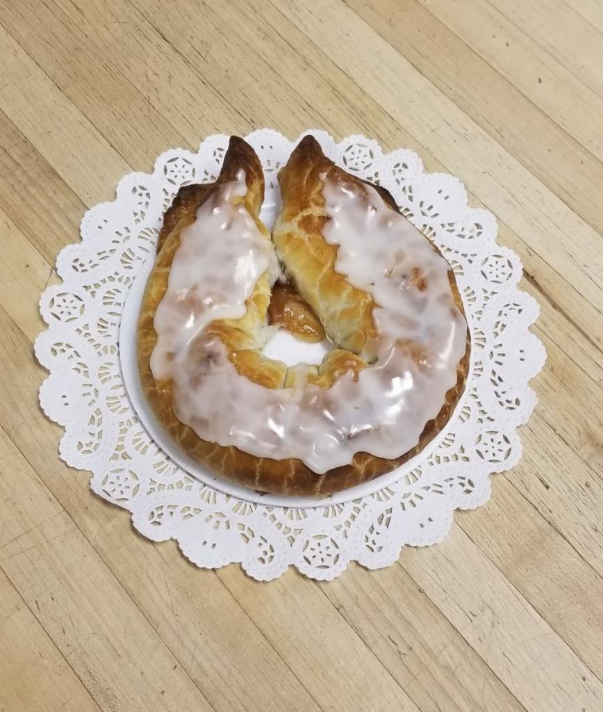 Apple Horn · Horseshoe shaped pastry filled with apples and spices, topped with white icing.
