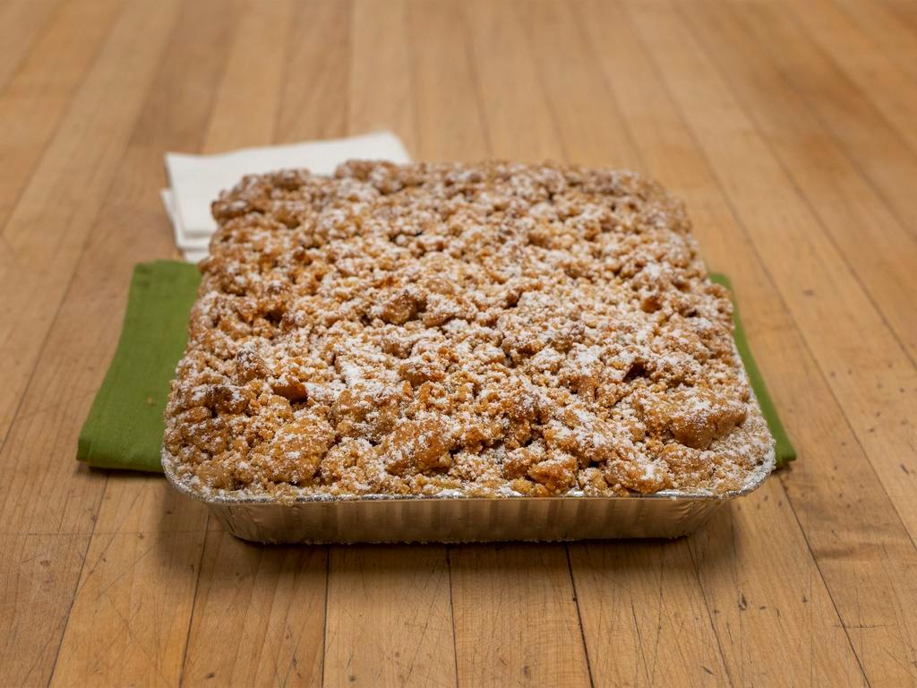 Apple Crumb Square · Square shaped piece of American (yellow) cake below thin layer of apple filling and topped with crumb.