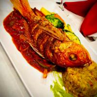 Fried Red Snapper · Served in a creole sauce mixed mofongo and sauteed vegetables in garlic.