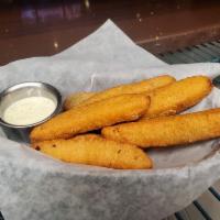 Fried Pickles · Deep fried breaded dill pickle spears served with housemade chipotle ranch.
