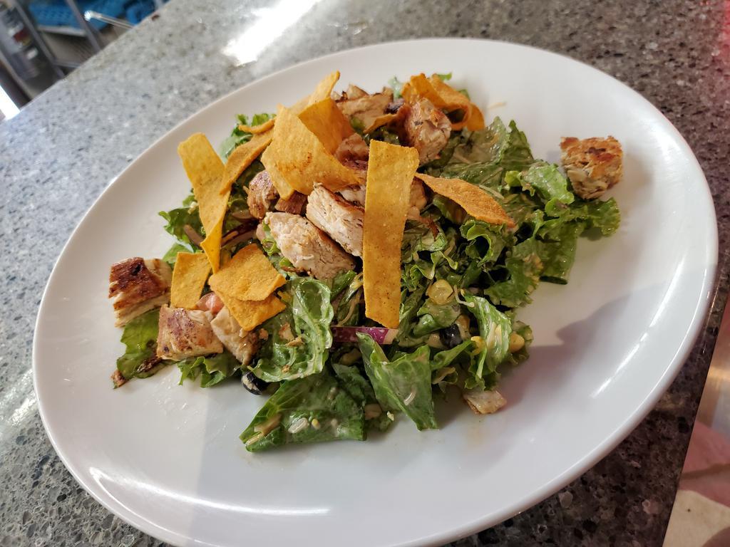 Southwest Chicken Salad · Mixed greens, Southwest seasoned chicken, tomato, corn, black beans, red onions, topped with fried tortilla strips & served with chipotle ranch dressing.
