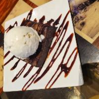 Brownie · Vanilla bean ice cream drizzled in your choice of raspberry or chocolate sauce, on a warm br...