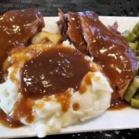 Hot Beef Fridays!! · Tender and flavorful hot beef smothered in brown gravy. Served with Mashed potatoes, brown g...
