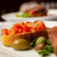 Bruschetta · Toasted bread topped with chopped marinated tomatoes, olive oil and basil.