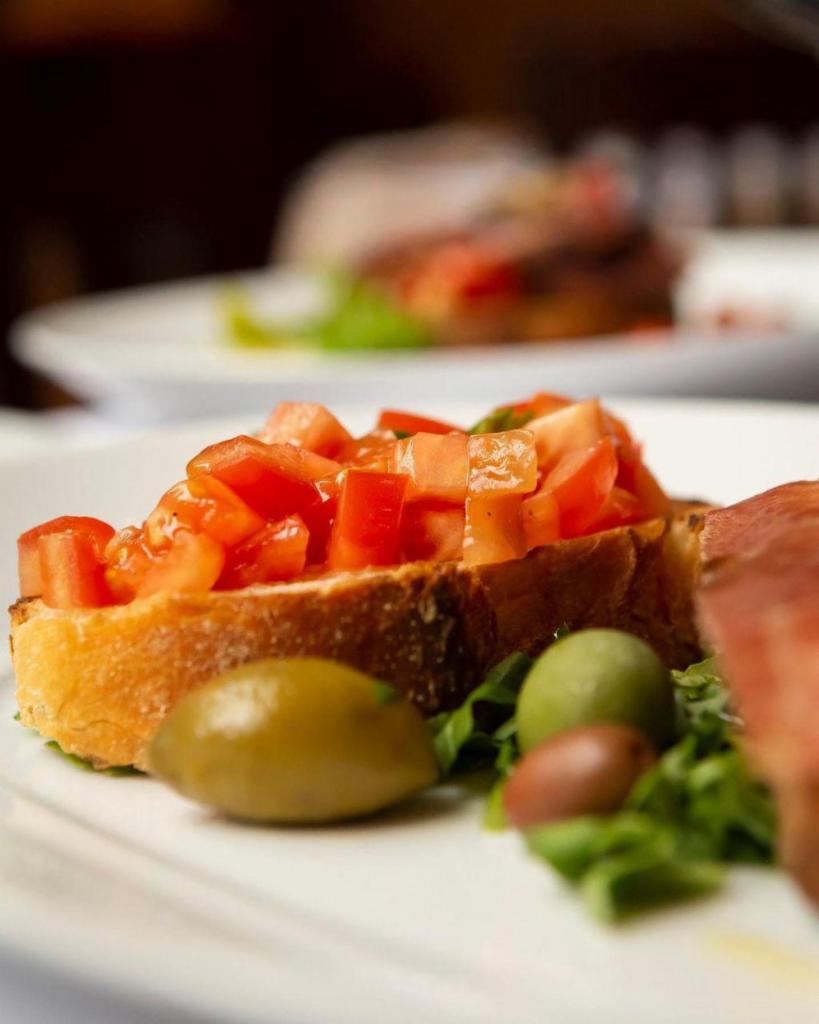 Bruschetta · Toasted bread topped with chopped marinated tomatoes, olive oil and basil.