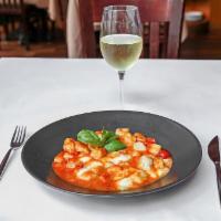 Gnocchi Sorrentina · Homemade gnocchi pasta with mozzarella and basil in a tomato sauce. Vegetarian.