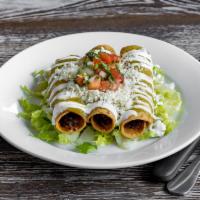 Flauta · 3 crispy chicken tacos served over lettuce, topped with salsa verde, queso fresco, crema.
