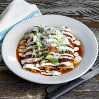 Enchilada · Rolled corn tortilla topped with queso fresco, lettuce, crema, pico de gallo. Comes with ver...