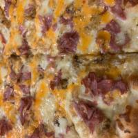 12” Reuben Pizza  · White pizza topped with golden fried sauerkraut, Swiss, corned beef and Russian dressing. A ...