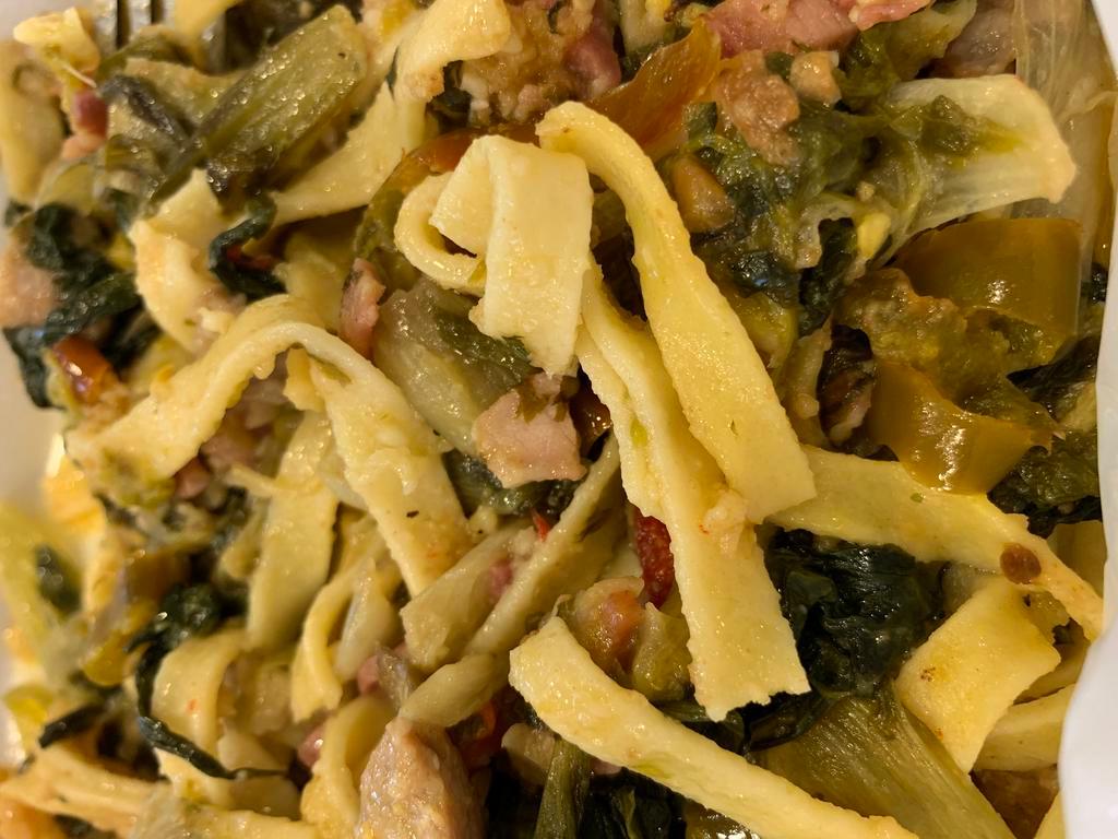 Utica Greens Fettuccine w/sausage · Utica greens with sausage, prosciutto, cherry peppers, breadcrumbs over our homemade fettuccine, topped with Asiago cheese.