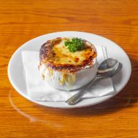 French Onion Au Gratin Soup · Bowl of french onion with savory freshly made croutons topped with melted gruyere and swiss ...