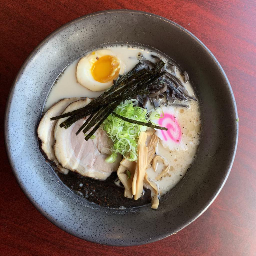 Tonkotsu Ramen Bowl · Thin noodles in our special rich, milky, chicken and pork bone broth topped with braised pork belly, scallions, bamboo shoots, kikurage mushrooms, fish cake and half boiled egg.