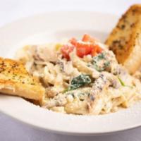 Chicken Fettuccine Alfredo · Sauteed garlic, mushrooms, tossed in a bed of linguine in an Alfredo sauce, topped diced tom...