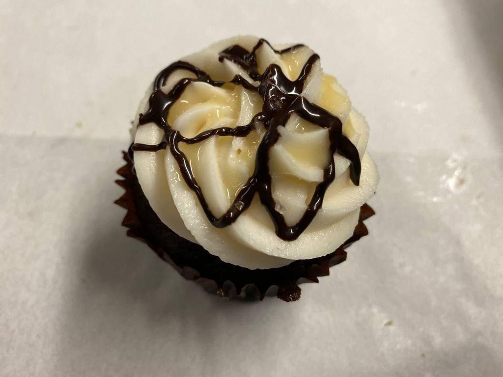 Salted Caramel Cupcake · Gluten Free & Vegan. Rich chocolate base with a vanilla buttercream. Topped off with chocolate and caramel drizzle. Light sprinkle of sea salt. Contains: coconut, soy lecithin