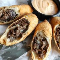 Cheesesteak Eggrolls · Scratch-made with certified Angus beef, cooper sharp cheese. Served with a side of chipotle ...