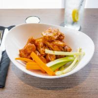 Wings · 8 pieces. Chicken wings. Served with celery, carrots, and ranch or blue cheese dressing on t...
