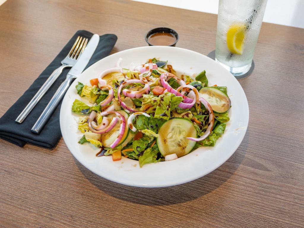 The Garden Salad · Iceberg and hearts of romaine tossed with cucumber, shredded carrots, jersey tomatoes, red onion, and balsamic vinaigrette. Add grilled chicken and crumbled bacon for an additional charge.