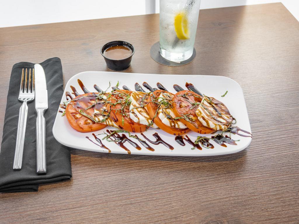 Caprese Salad · Layered jersey tomatoes, fresh mozzarella cheese, chopped basil, and balsamic glaze drizzle. Add grilled chicken and crumbled bacon for an additional charge.
