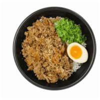 Beef rice box 牛肉盖饭 · Thinly sliced beef and onion cooked in sweet soy sauce then paired with egg and green onion.