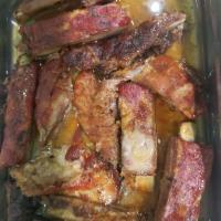 85. Costillas a la BBQ lunch · BBQ pork spare ribs. Served with rice and beans.