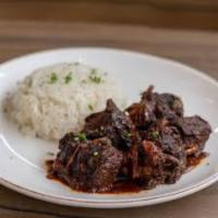 90. Chivo Guisado lunch · Goat stew. Served with rice and beans.