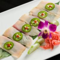 A13. Yellowtail Jalapeno · Slices of yellowtail oncucumber, with ponzu sauce, jalapenos and chili sauce,