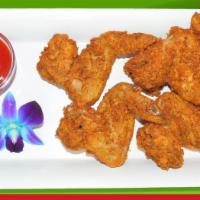 Chicken Wings · Cooked wings of a chicken coated in sauce or seasoning. 5 pieces.
