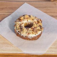 Carrot Cake Donut · Toasted cashews, blistered carrot snips, gold mist.