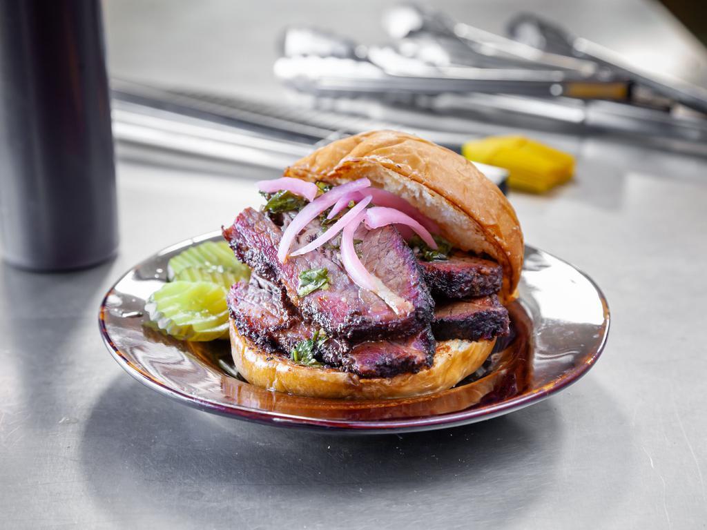 Brisket Sandwich · Slow smoked, red wine and rosemary, sliced Angus beef brisket on a challah bun. Available with housemade BBQ sauce, chimichurri, pickles, and onions. Add potato salad for an additional charge.