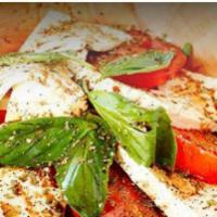 Caprese Salad · Fresh mozzarella, fresh tomatoes, basil
and mixed greens
Extra virgin olive oil and balsamic 