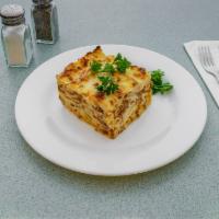 Pastichio · Layered macaroni with chopped meat, grated cheese and bechamel cream sauce and baked to a go...