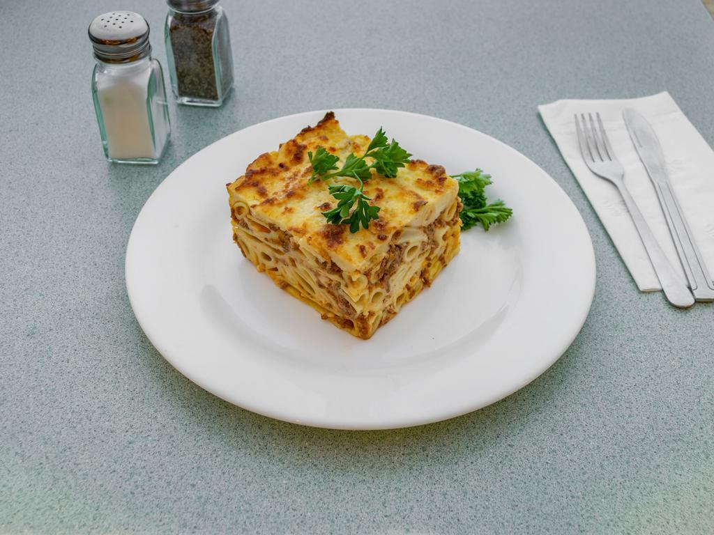 Pastichio · Layered macaroni with chopped meat, grated cheese and bechamel cream sauce and baked to a golden brown. Served with side Greek salad.