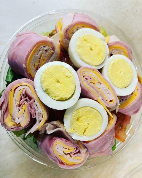 79. Chef's Salad · Rolled up roast beef, turkey, ham and Swiss cheese over crispy greens with tomato and hard boiled egg.
