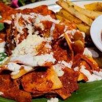 Chilaquiles Rojos · tortilla chips covered with  red salsa mozzarella cheese black refried beans dice potatoes t...