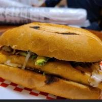 Birria Torta La Mamalona · Mexican bun toasted and  covered with black beans your choice of shredded beef lamb, carnita...