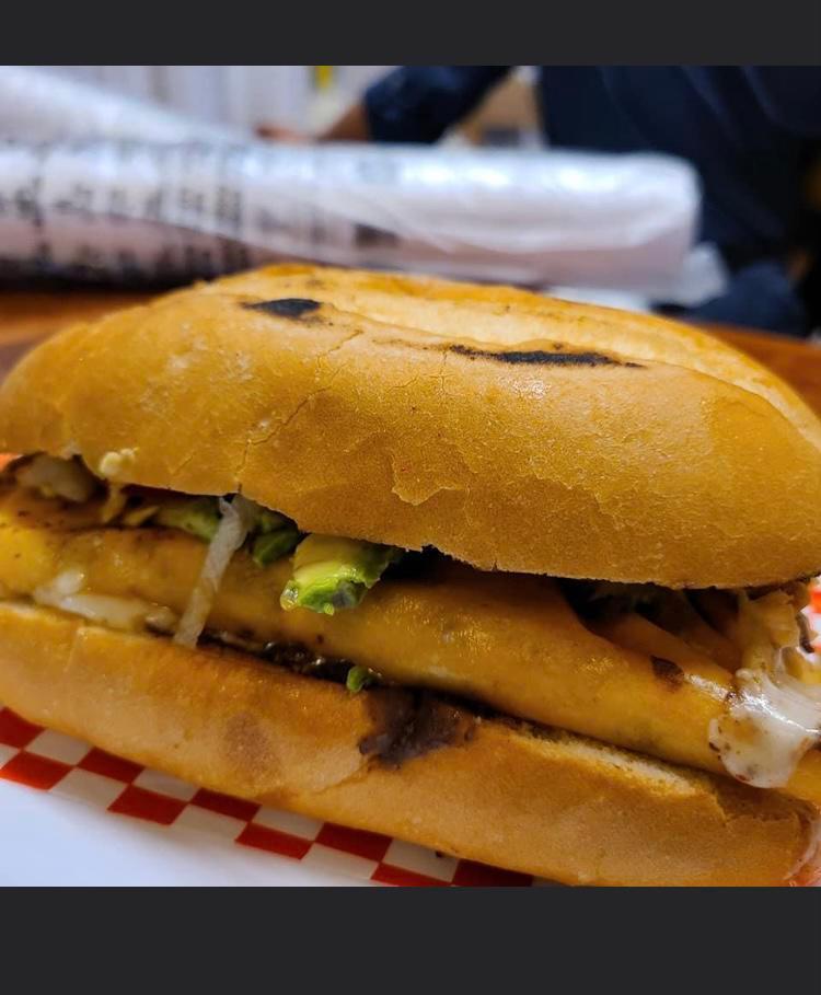 Birria Torta La Mamalona · Mexican bun toasted and  covered with black beans your choice of shredded beef lamb, carnitas or pastor include two slice of turkey ham slice of  grilled queso fresco  or mozzarella cheese  lettuce tomatoes avocado and slice jalapenos 