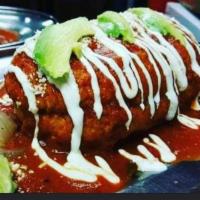 Ahogada de Borrego · toasted Mexican bun  covered with black refried beans your choice of meat lamb or shredded b...